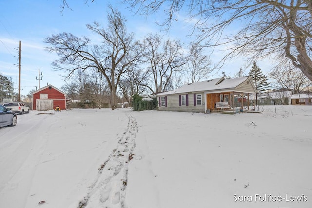 yard covered in snow featuring a porch