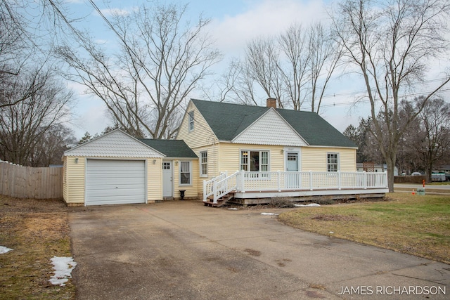 view of front of home featuring driveway, fence, a wooden deck, a shingled roof, and a garage