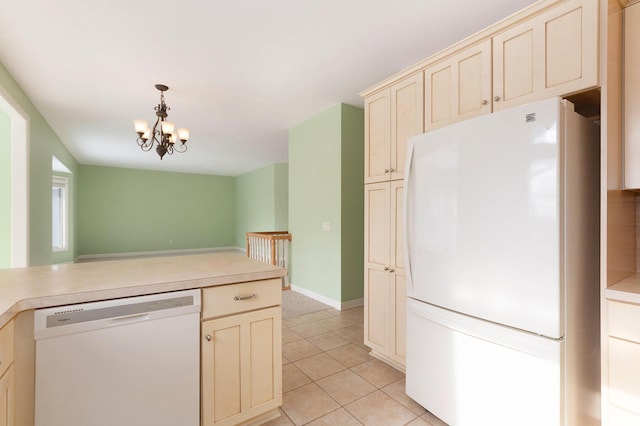 kitchen with pendant lighting, light tile patterned floors, a notable chandelier, cream cabinets, and white appliances