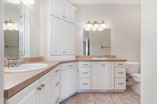 bathroom featuring vanity, toilet, and tile patterned flooring