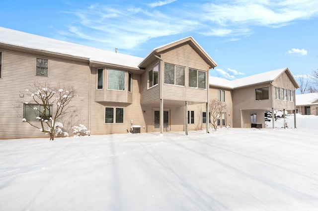 snow covered house with cooling unit