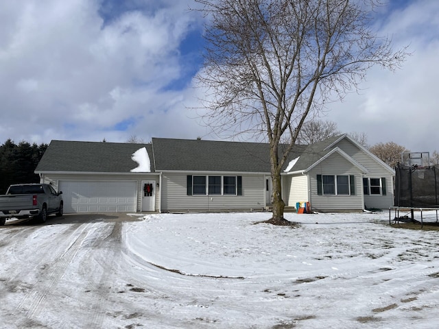 view of front of house with a trampoline and a garage