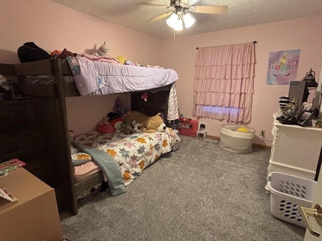 carpeted bedroom featuring ceiling fan and a textured ceiling