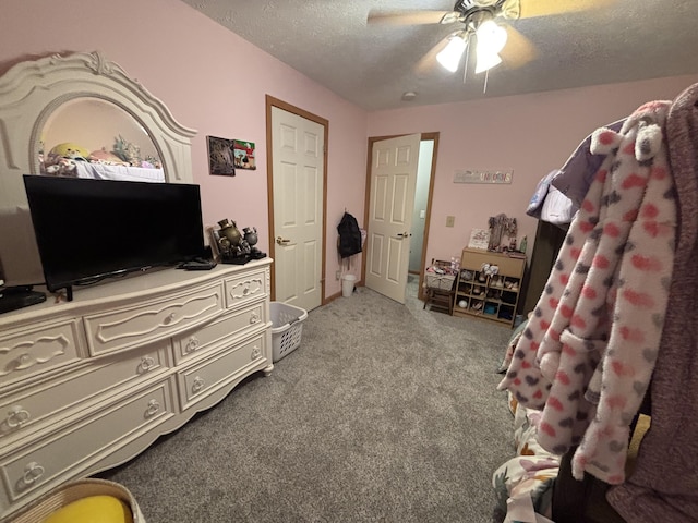 carpeted bedroom with a textured ceiling and ceiling fan