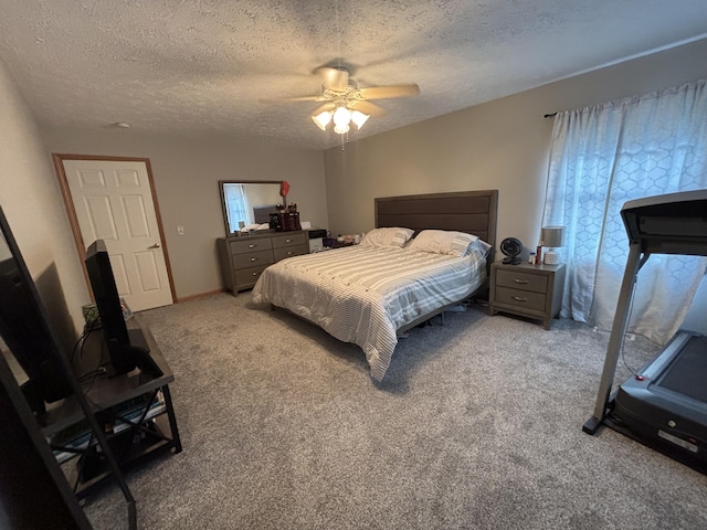 carpeted bedroom with ceiling fan and a textured ceiling