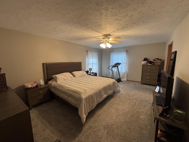 bedroom featuring a textured ceiling, ceiling fan, and dark carpet