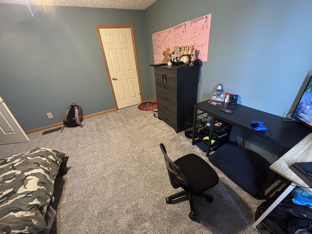 office area featuring a textured ceiling and carpet flooring