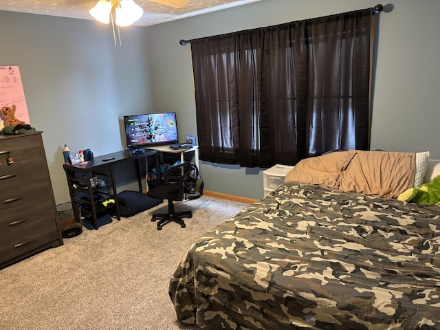 carpeted bedroom with a textured ceiling and ceiling fan