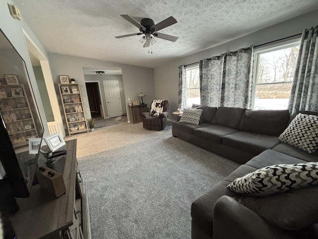 carpeted living room with ceiling fan, a textured ceiling, and a healthy amount of sunlight