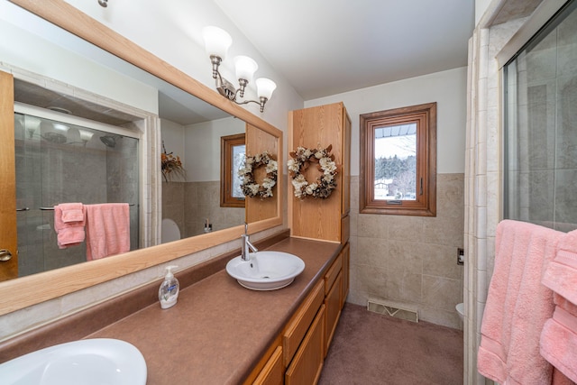 bathroom with vanity, tile walls, an enclosed shower, and toilet