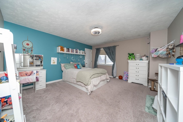 bedroom with a textured ceiling and light colored carpet