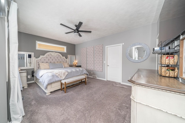 carpeted bedroom with ceiling fan and a textured ceiling