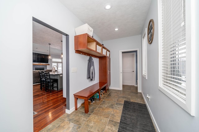 mudroom with a textured ceiling