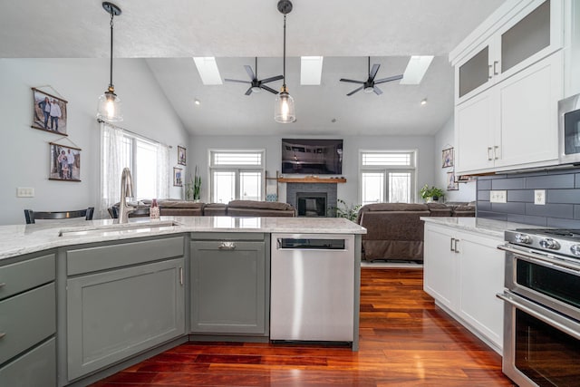 kitchen featuring decorative light fixtures, white cabinetry, stainless steel appliances, sink, and gray cabinets