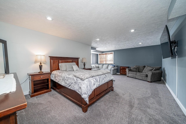 bedroom featuring a textured ceiling and carpet flooring