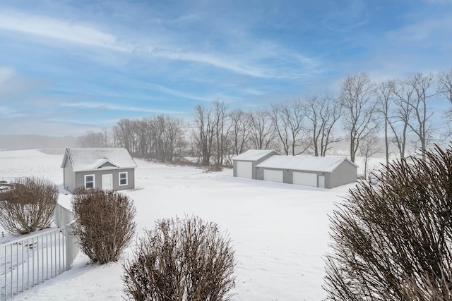 snow covered property with a garage