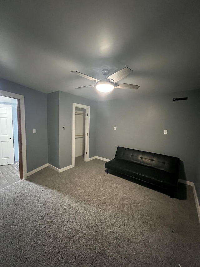 interior space with carpet floors and ceiling fan