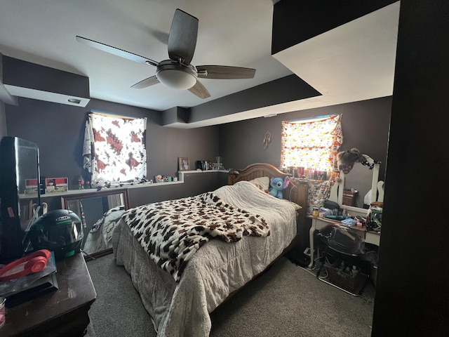 bedroom featuring ceiling fan and dark colored carpet