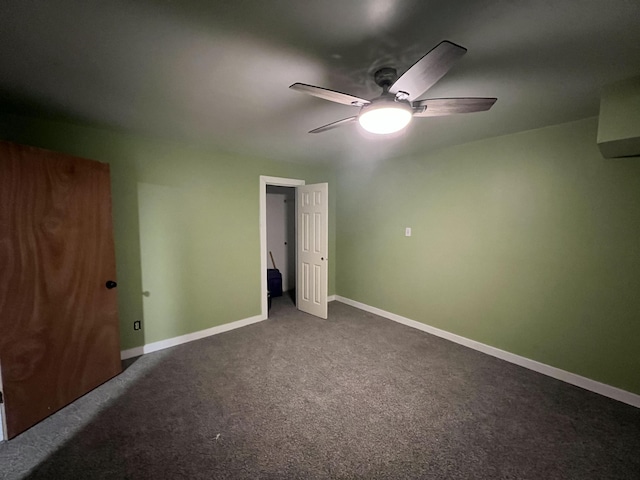 unfurnished bedroom with ceiling fan and dark carpet