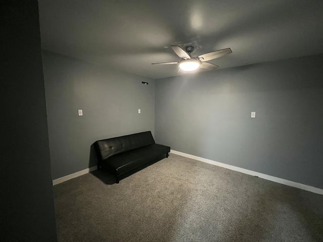 unfurnished room featuring ceiling fan and dark carpet