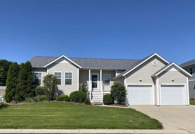 single story home featuring a front lawn, a garage, and a porch