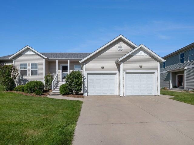 single story home featuring a garage and a front yard