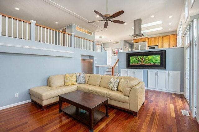 living room with ceiling fan and dark hardwood / wood-style floors