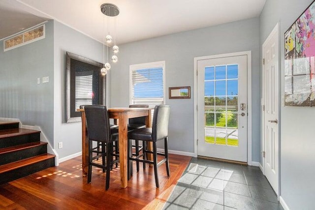 dining space with dark wood-type flooring