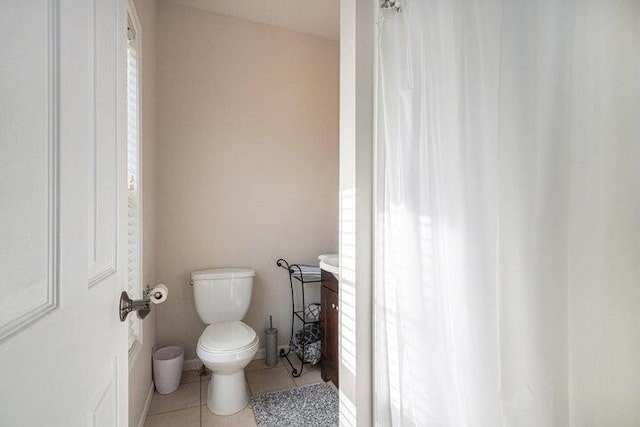 bathroom with toilet and tile patterned floors