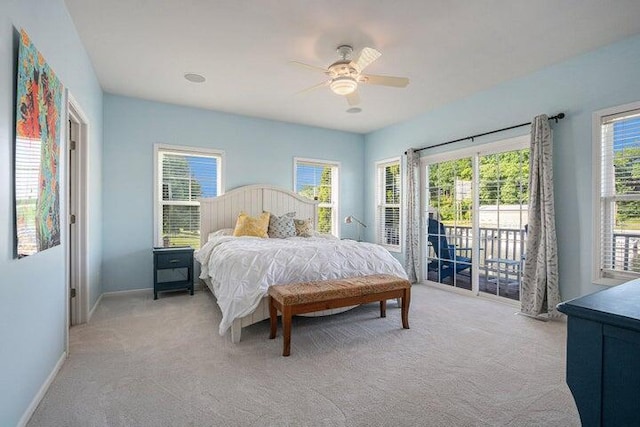 carpeted bedroom with ceiling fan and access to exterior