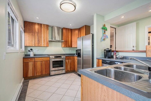 kitchen featuring light tile patterned floors, sink, appliances with stainless steel finishes, and wall chimney range hood