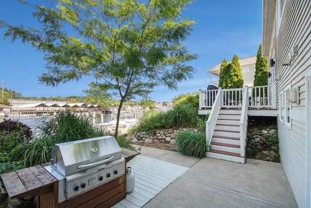 view of patio featuring a wooden deck and area for grilling