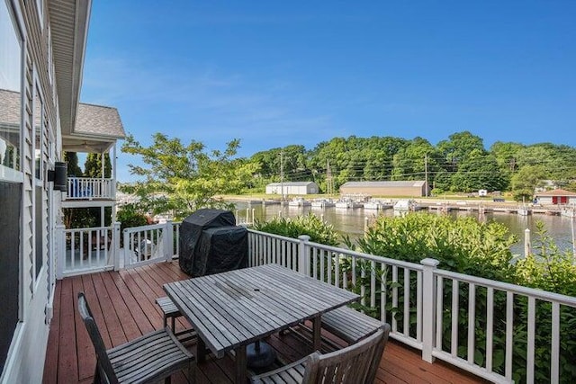 wooden deck featuring area for grilling and a water view