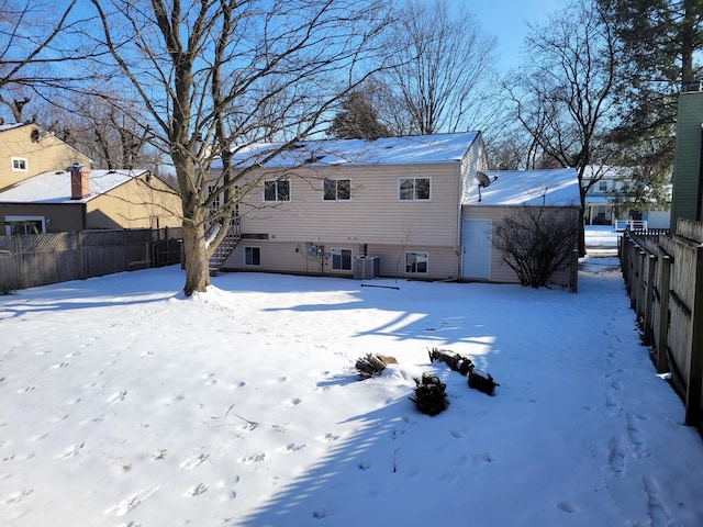 snow covered property with cooling unit