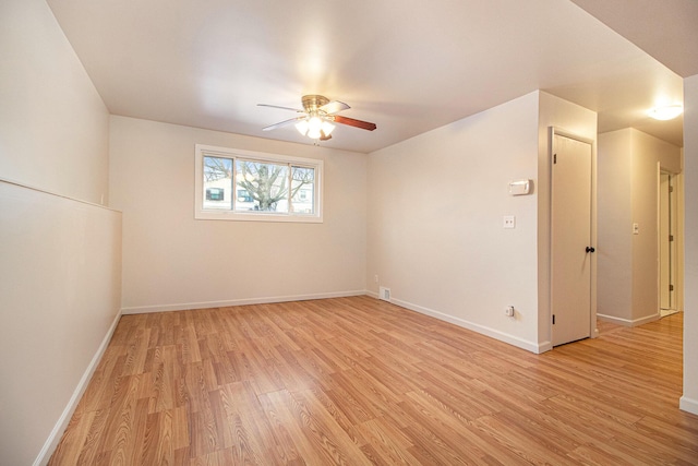 empty room featuring ceiling fan and light hardwood / wood-style floors