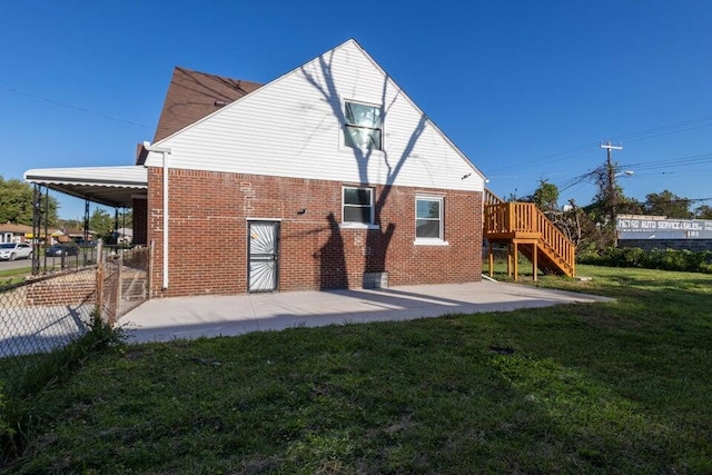 rear view of property featuring a yard and a patio