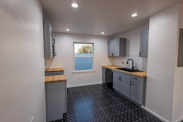 kitchen with black dishwasher, gray cabinetry, wooden counters, and sink