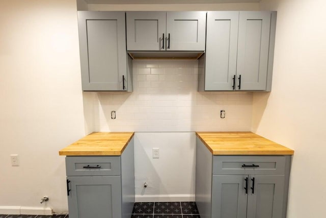 kitchen featuring gray cabinetry and wooden counters