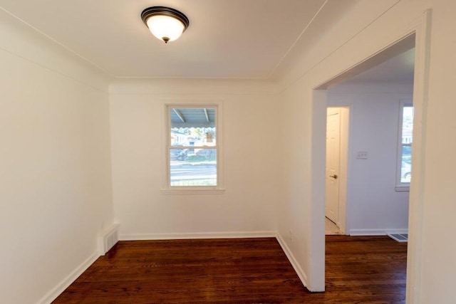 unfurnished room with dark hardwood / wood-style flooring