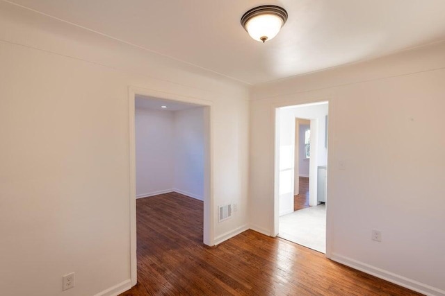 spare room featuring dark hardwood / wood-style floors