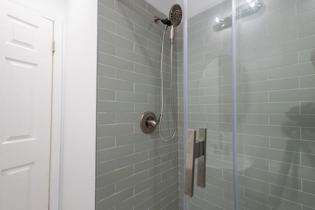 bathroom featuring a shower with door