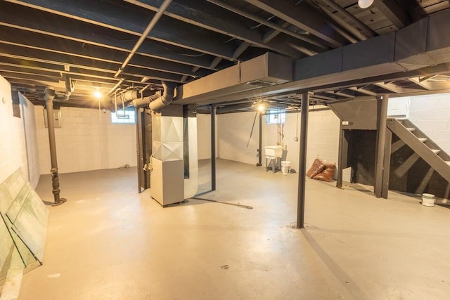 basement with heating unit and sink