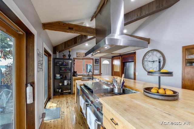 kitchen with sink, island range hood, lofted ceiling with beams, stainless steel appliances, and hardwood / wood-style floors