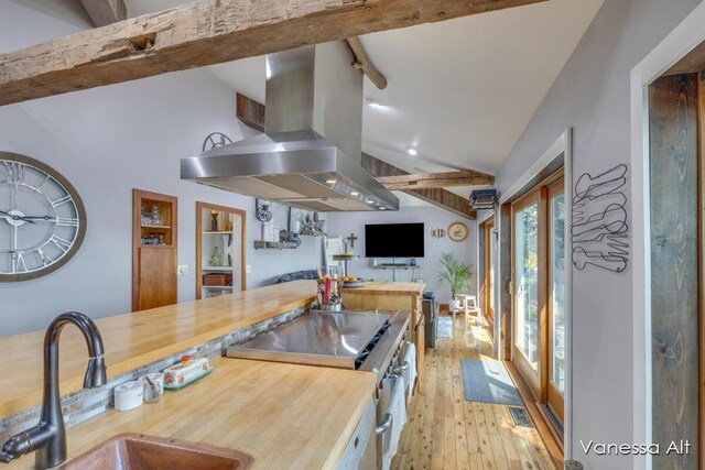 kitchen with stainless steel electric range, lofted ceiling with beams, sink, island exhaust hood, and light hardwood / wood-style flooring