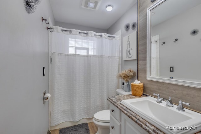 bathroom featuring vanity and toilet