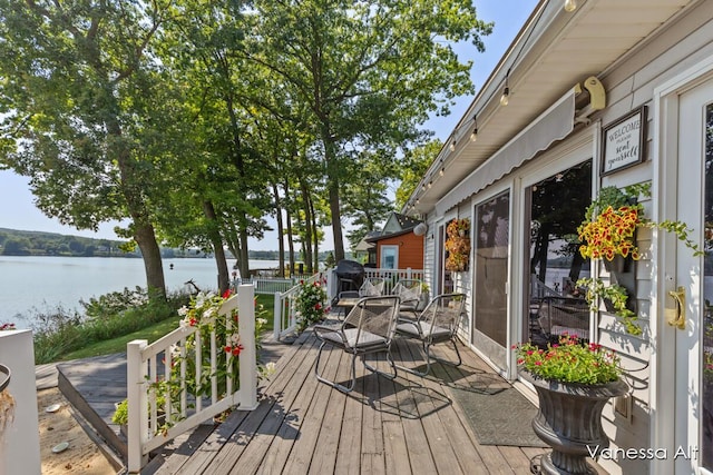 wooden deck with a water view