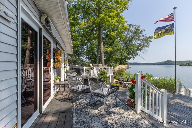 wooden terrace featuring a water view