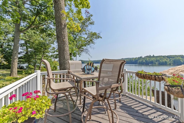 wooden terrace featuring a water view