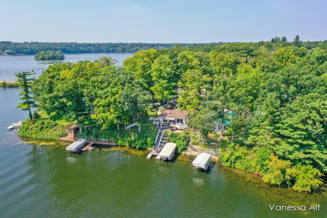 birds eye view of property with a water view