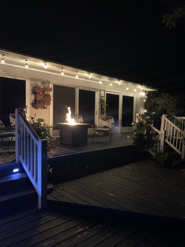 deck at twilight featuring a fire pit